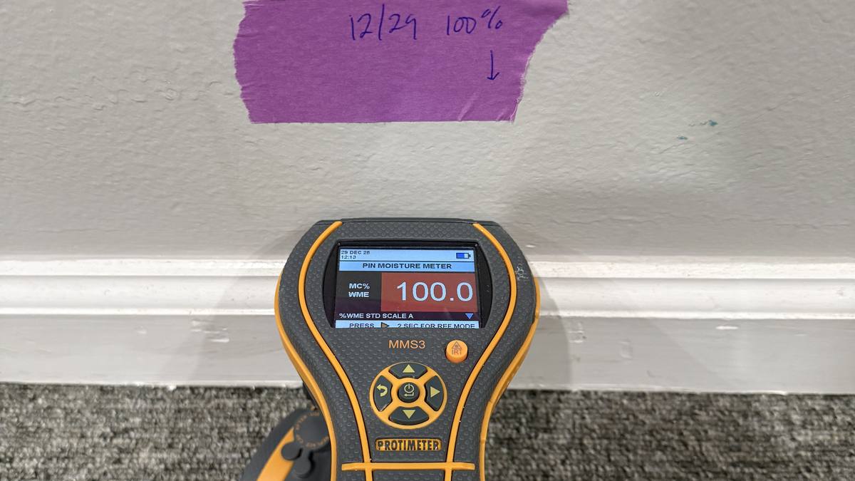 Moisture meter documenting a wall reading for a Charleston insurance claim