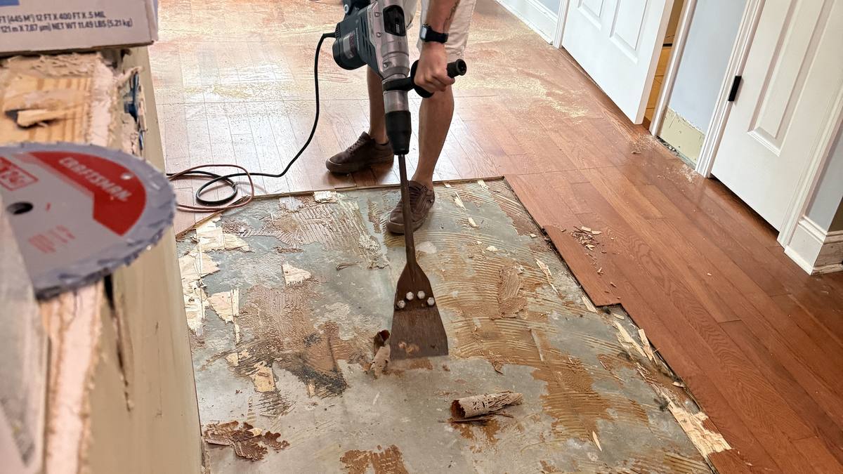 DRYmedic technician removing water-damaged flooring in a Charleston home